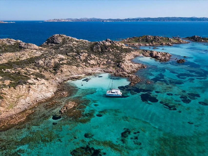 Catamaran anchored off a La Maddalena cove